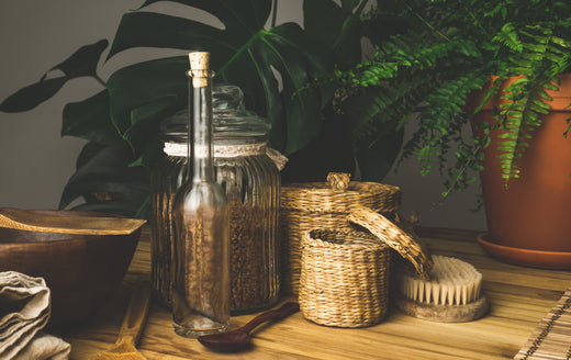 a bottle, jar, and containers in the wooden table