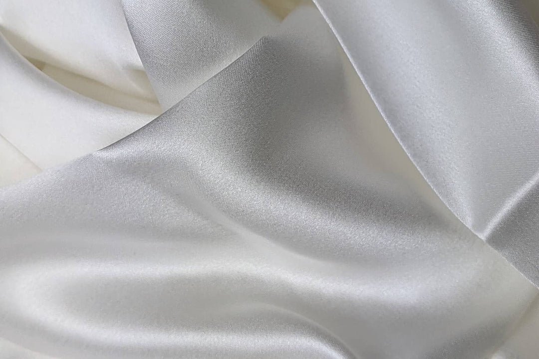white silky unfolded bed sheet