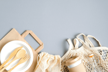 shopping bags, spoon, fork, and bread knife that are made of bamboo