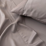 Luxurious grey satin bed linen set, with Linenly's Bamboo Pillowcase Set - Stone Terrace, emphasizing the soft texture and elegant stitching detail for a comfortable sleep.