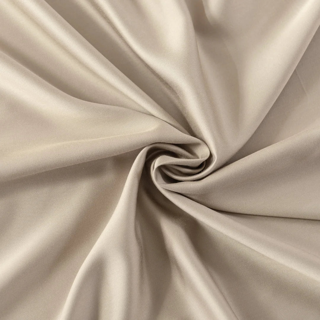 A close-up of a Linenly Bamboo Pillowcase Set in Taupe, elegantly draped and twisted at the center to showcase its smooth texture and graceful flow.