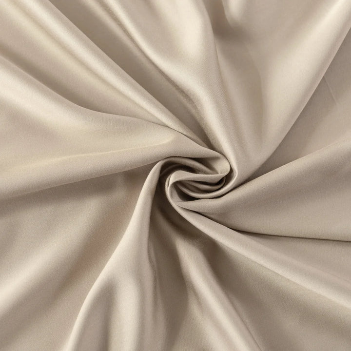 A close-up of a Linenly Bamboo Pillowcase Set in Taupe, elegantly draped and twisted at the center to showcase its smooth texture and graceful flow.