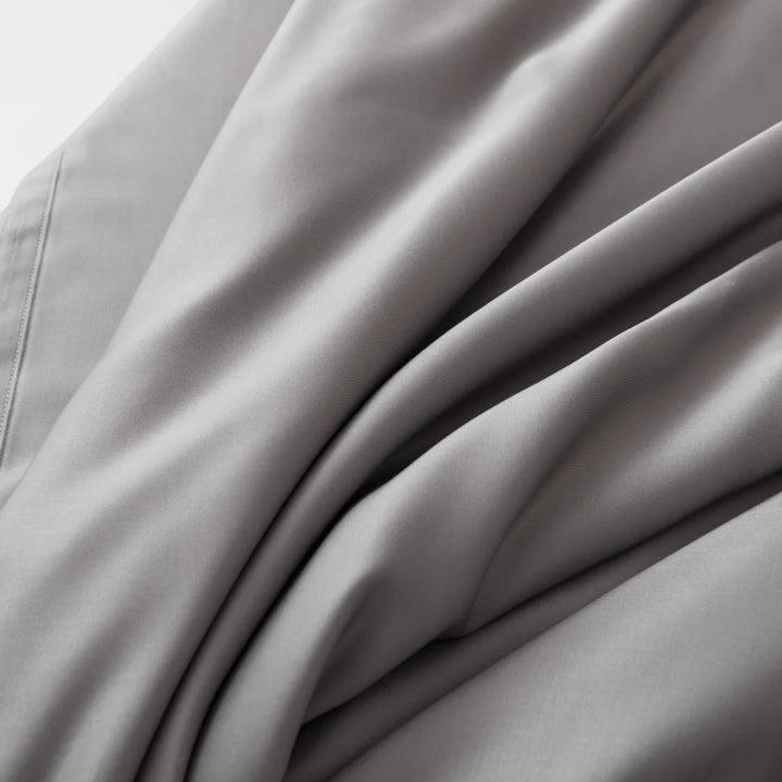 Close-up of Linenly's Bamboo Sheet Set in Stone Grey, with elegant folds woven from sustainable bamboo fibers.