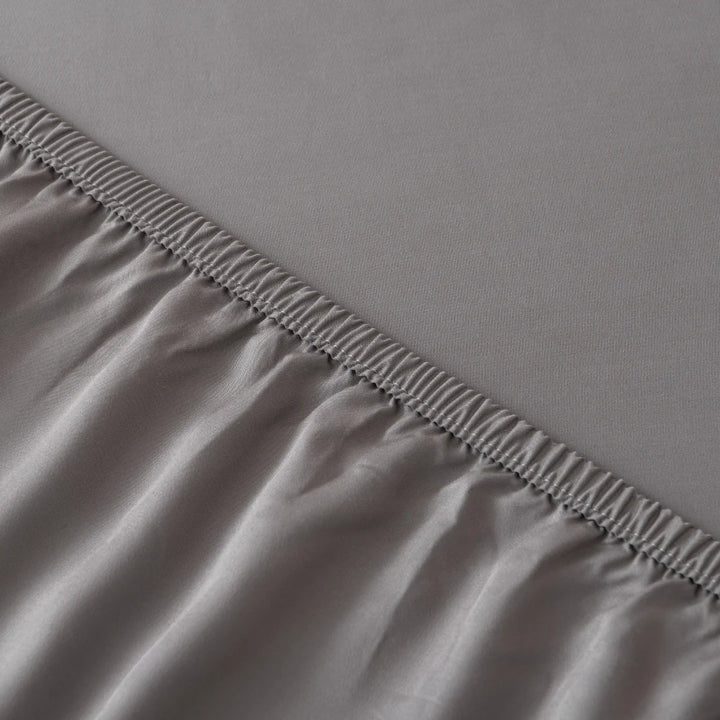 Close-up of a neat overlock seam on Linenly's stone grey bamboo sheet set, illustrating the detail of sustainable textile finishing.