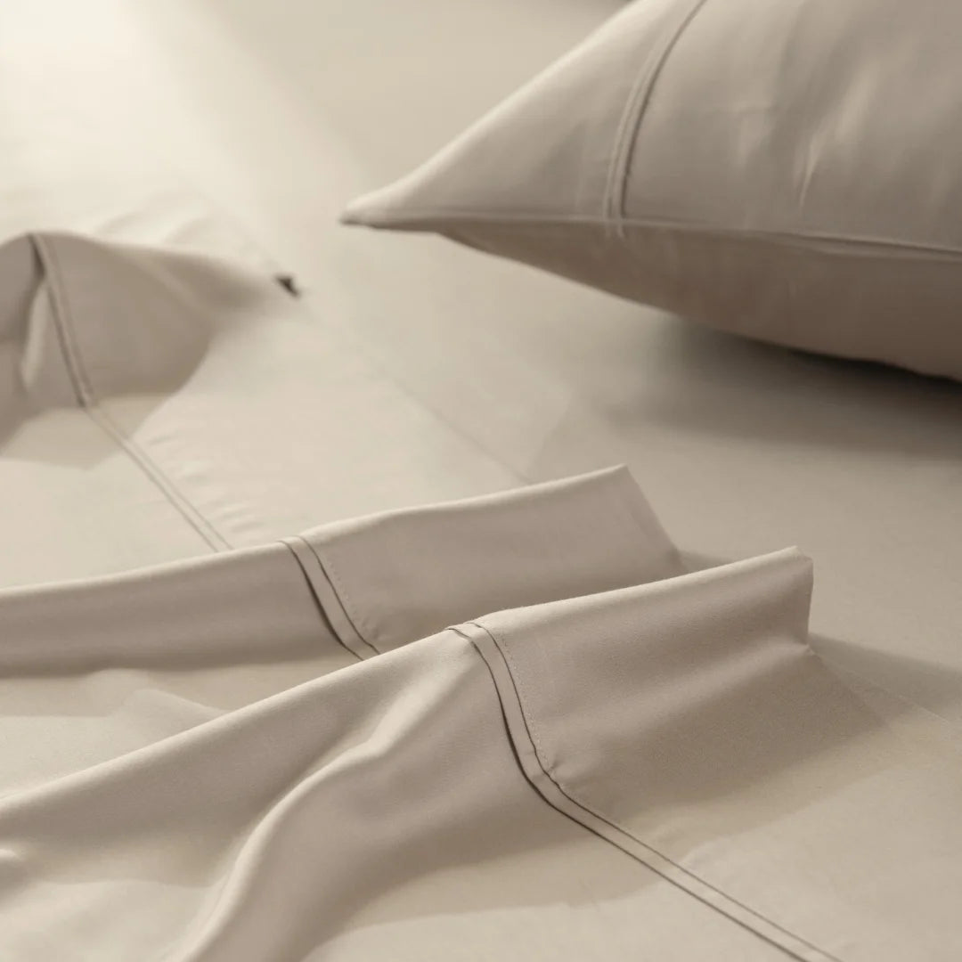 Luxurious simplicity: an elegantly made bed with silky, smooth Linenly Bamboo Sheet Set in a serene, taupe color palette.