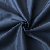A close-up of smooth dark blue fabric with spiral folds highlights the soft, slightly shiny texture of Linenly’s Luxe Cotton Sateen Pillowcase Set - Midnight, capturing its premium elegance.